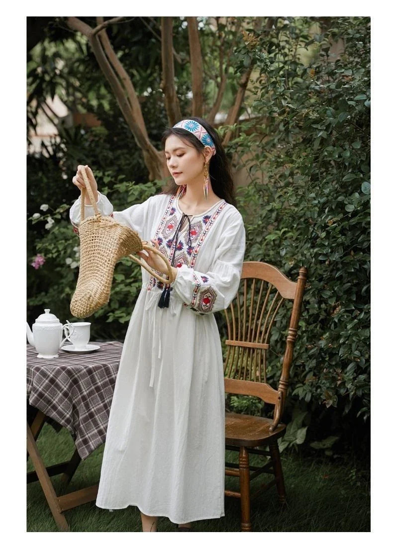 Elegant embroidered cotton-linen dress with tassels, featuring a waist-cinching A-line silhouette in vibrant colors