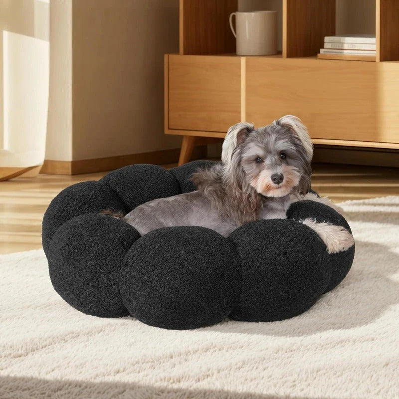 A cozy, flower-shaped dog bed made of soft, plush teddy sherpa fabric with raised edges for head and neck support, providing a calming and comfortable resting spot for medium-sized dogs.