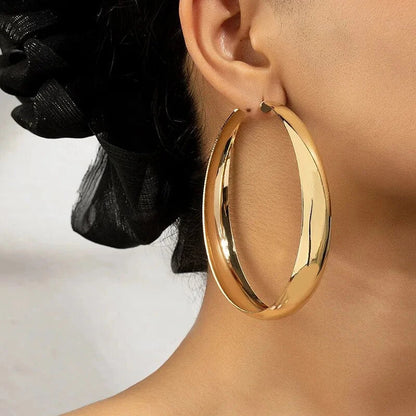 Glossy geometric metal hoop earrings in a silver finish, a trendy and versatile fashion accessory