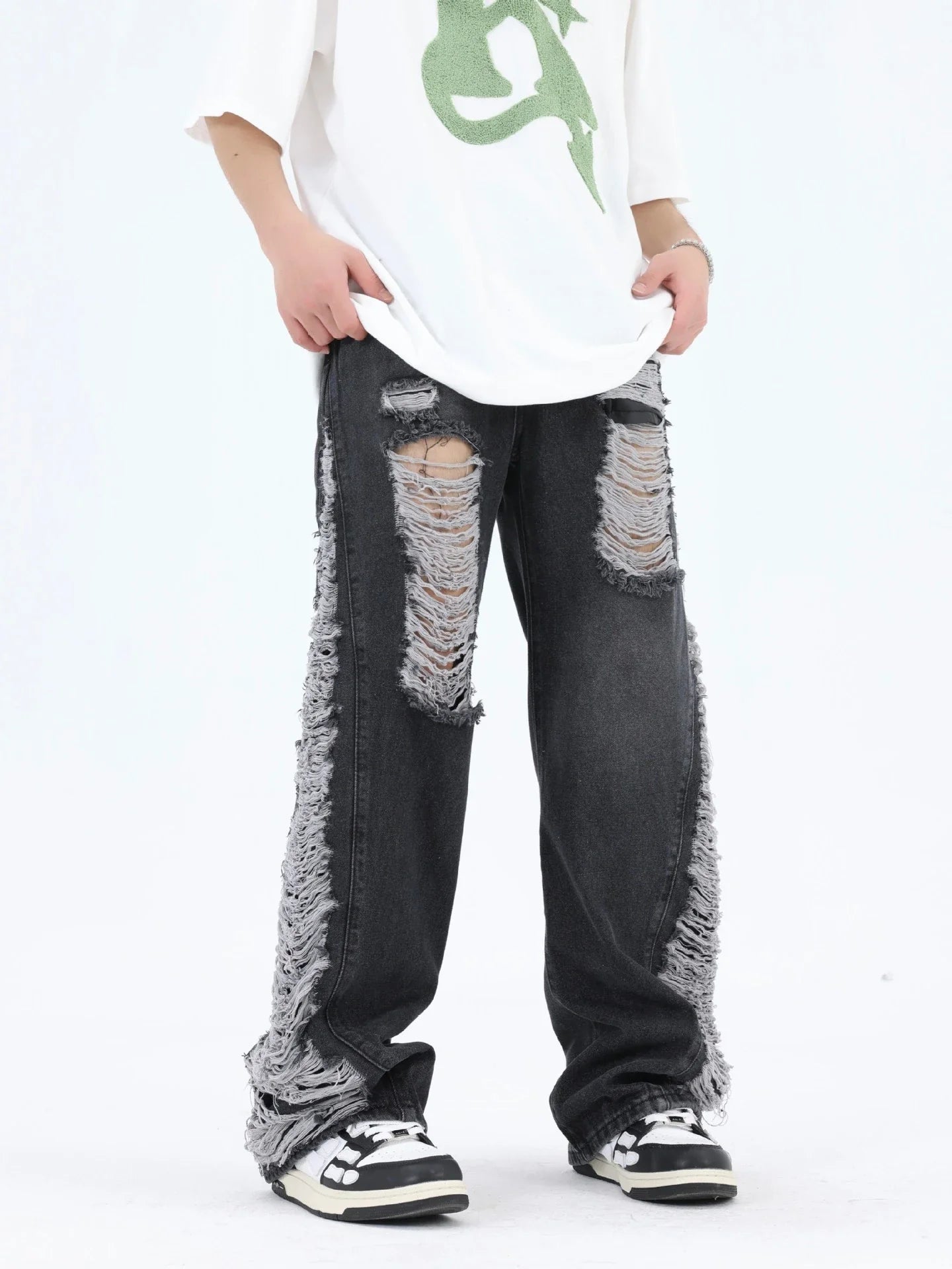Premium loose fit distressed denim trousers for men and women, featuring a relaxed silhouette, high-quality cotton construction, and trendy distressed details.
