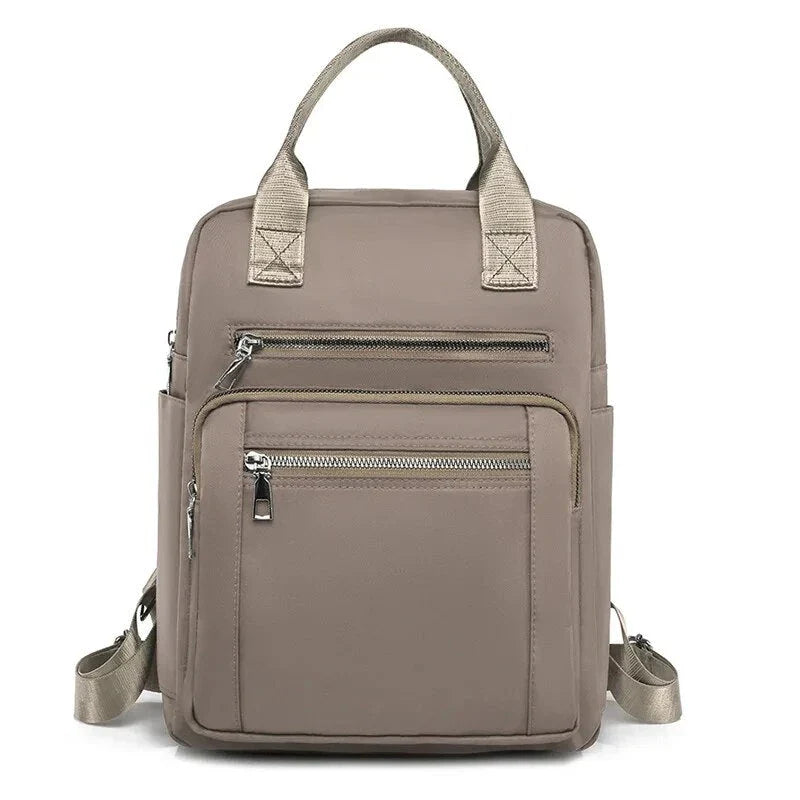 A stylish and durable Oxford cloth backpack with multiple compartments for organized storage and a sleek, portable design.