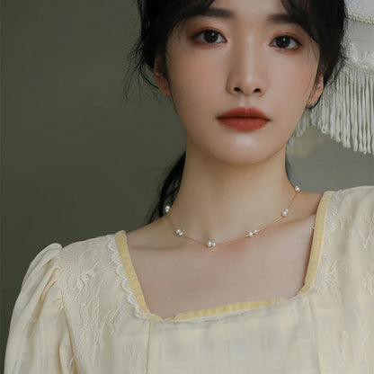 Elegant mother-of-pearl necklace with delicate butterfly and dragonfly motifs, inspired by Asian design