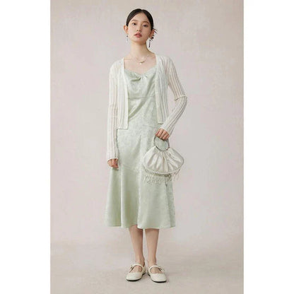 Elegant mint green midi dress with spaghetti straps, featuring a slim fit and intricate embroidery details