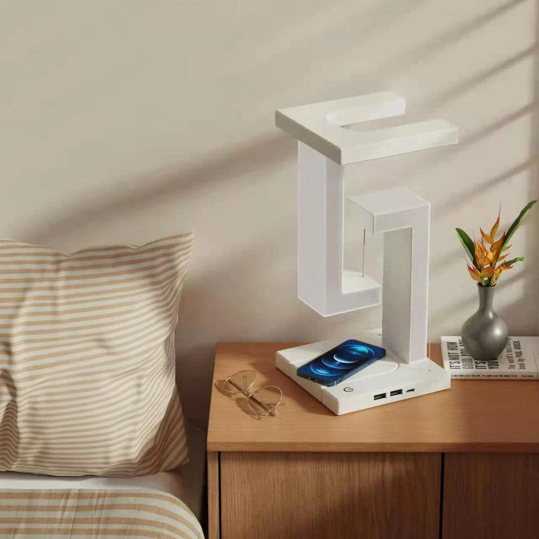 A modern, levitating desk lamp with wireless charging capabilities for smartphones