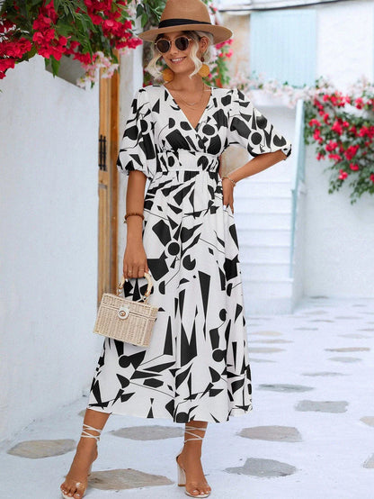 A stylish printed surplice dress with balloon sleeves, perfect for effortless elegance