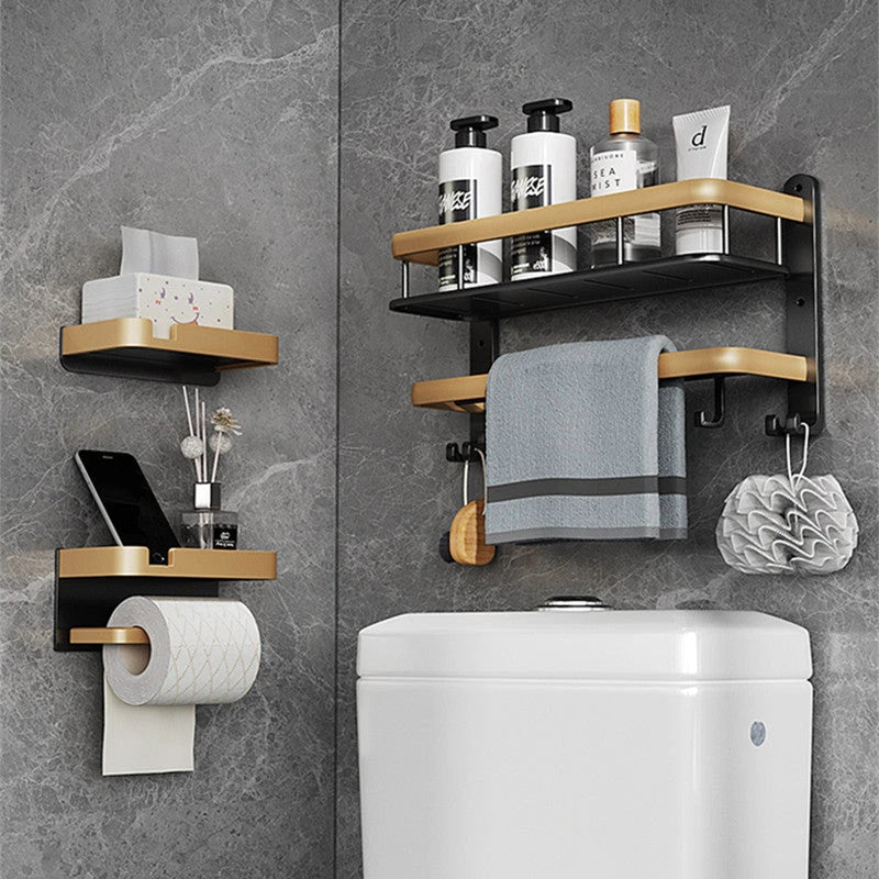 Black and gold aluminum bathroom paper holder with a convenient phone shelf, a stylish and functional accessory for modern bathrooms.