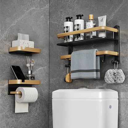 Black and gold aluminum bathroom paper holder with a convenient phone shelf, a stylish and functional accessory for modern bathrooms.