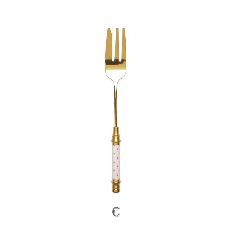 Elegant gold-plated dessert fork with intricate ceramic handle design