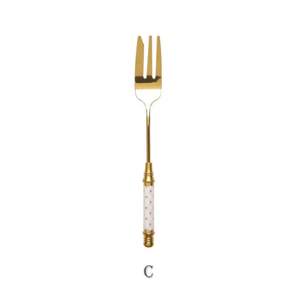 Elegant gold-plated dessert fork with intricate ceramic handle design