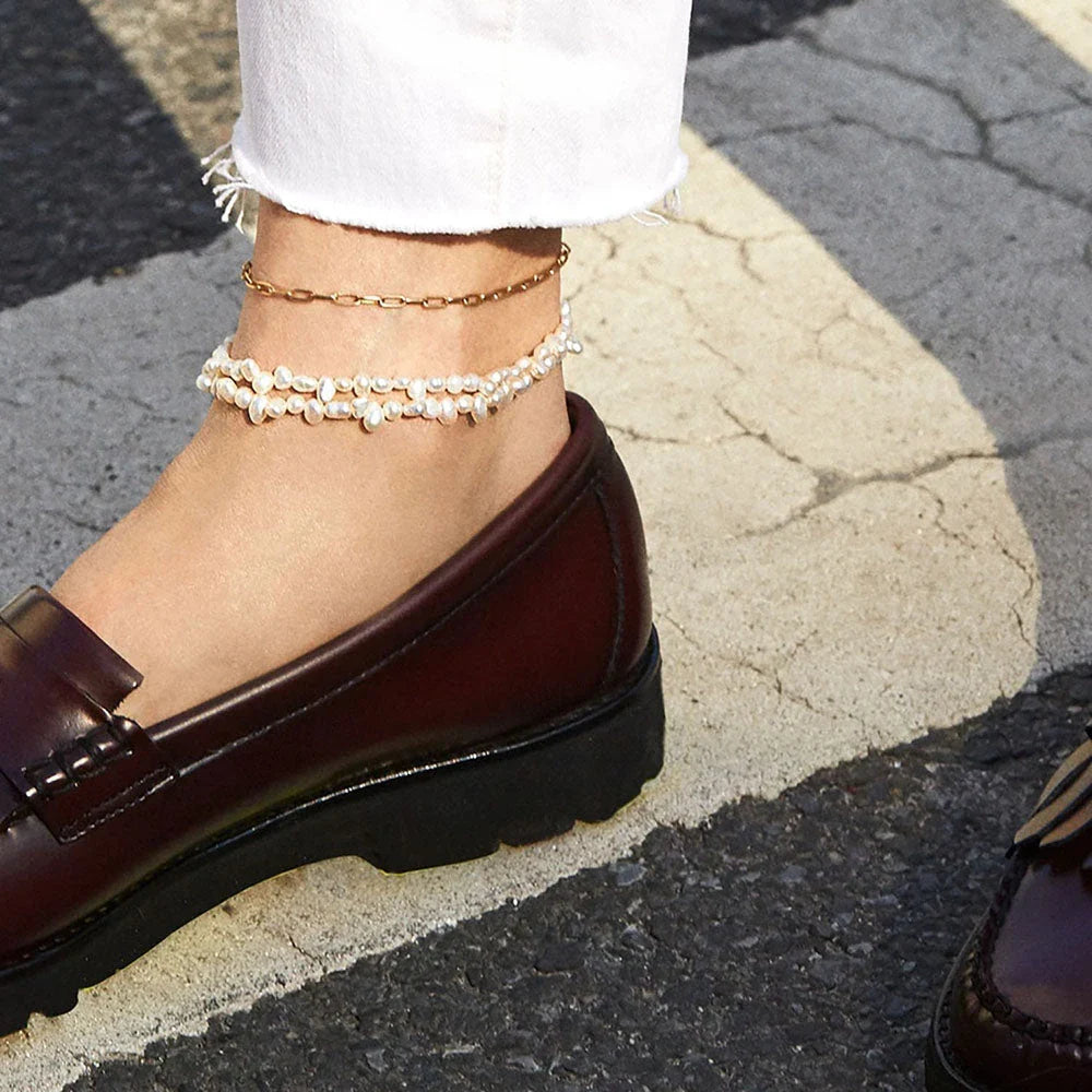A close-up view of a 18K gold-plated stainless steel paper clip chain anklet, showcasing its elegant and minimalist design.
