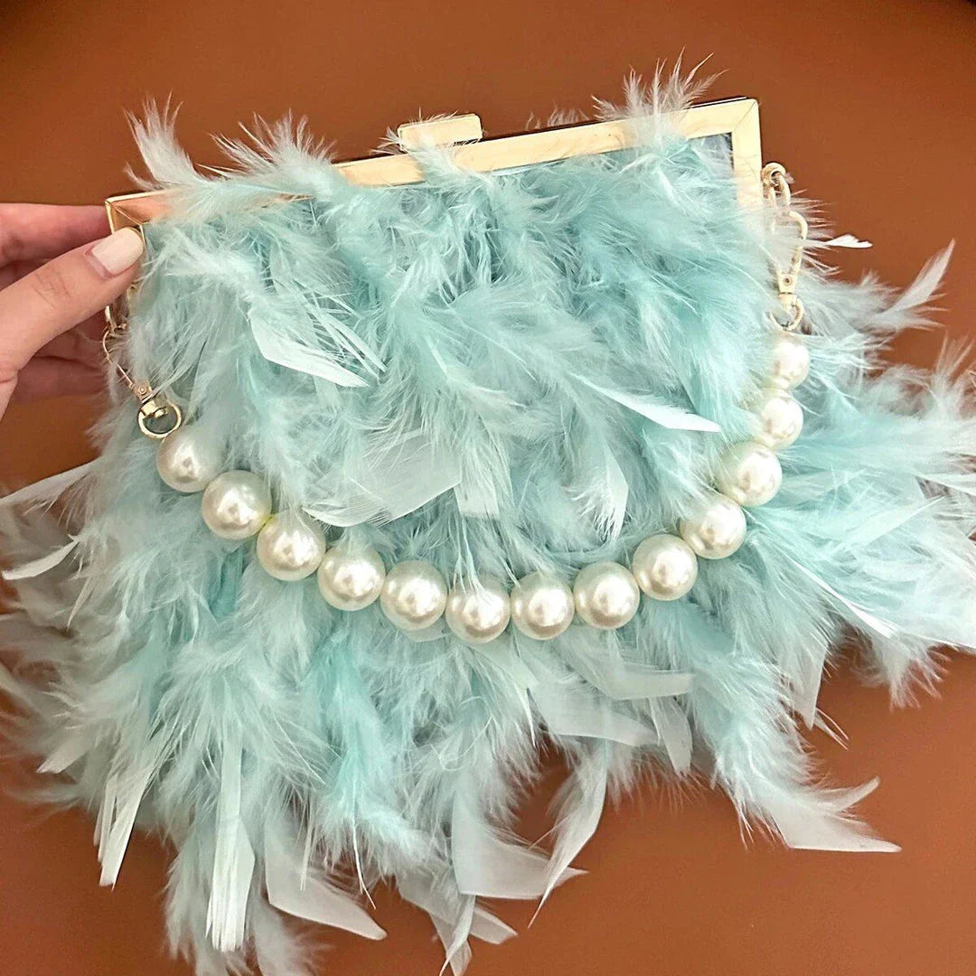 Elegant feather clutch bag with pearl embellishments and metal chain details