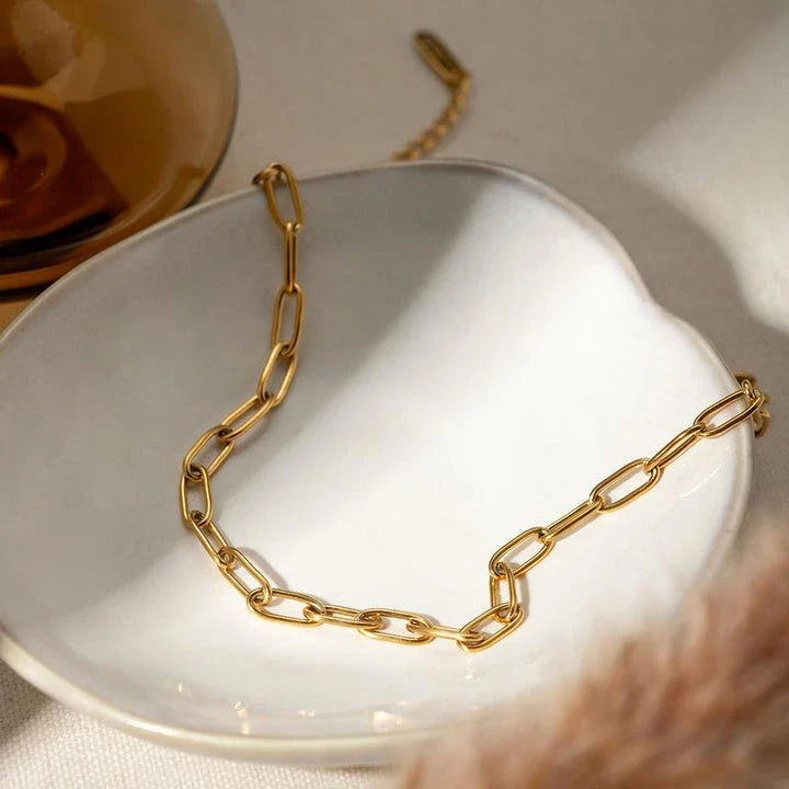 A close-up view of a 18K gold-plated stainless steel paper clip chain anklet, showcasing its elegant and minimalist design.