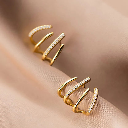 Elegant gold-toned zircon four-claw stud earrings with a classic cuff design, offering a sparkling and sophisticated look.