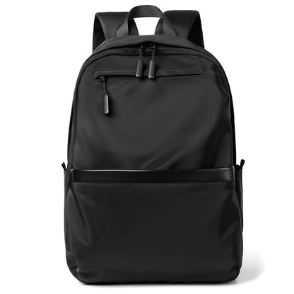 A large, simple, and stylish backpack made of durable nylon material with multiple compartments for organized storage and comfortable shoulder straps for easy carry.