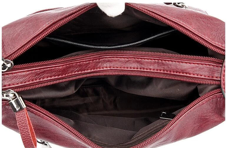 Stylish one-shoulder messenger bag in various colors with a soft, supple PU leather exterior and a spacious, organized main compartment