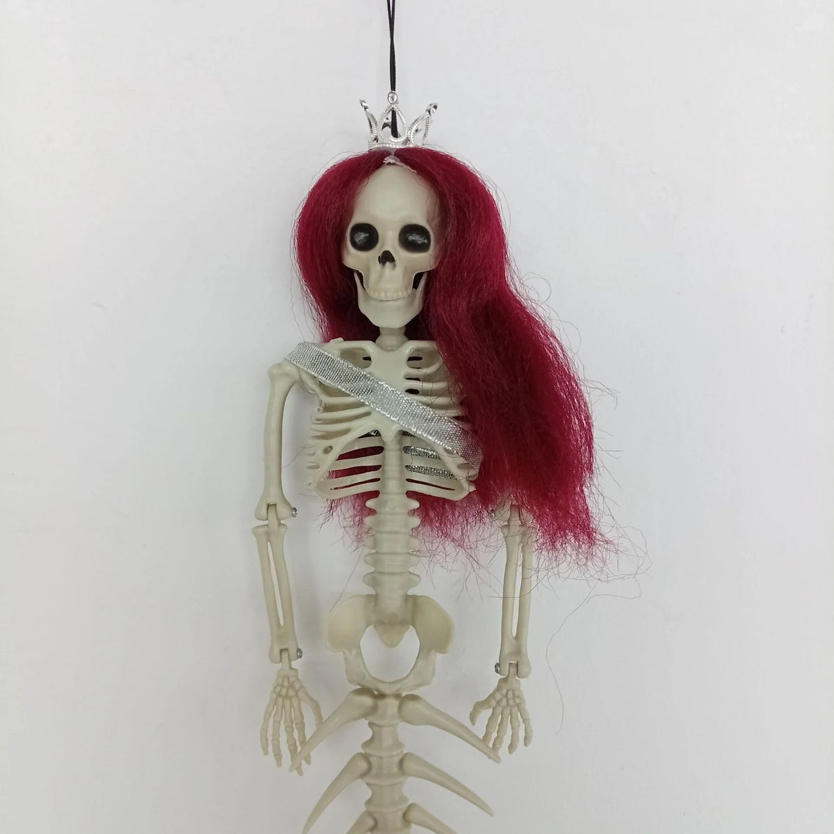 Mermaid bone pendant in various colors, including brown, dark purple, burgundy, and lake blue, hanging outdoors for Halloween decoration