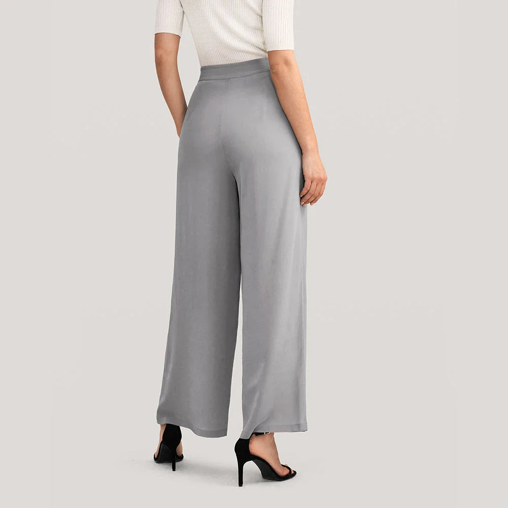 Elegant grey silk wide-leg pants with a high-waist design and concealed side zipper for a flattering, comfortable fit.