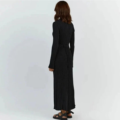 Timeless elegant pleated knit dress in black, perfect for summer office wear with a sophisticated and comfortable design.