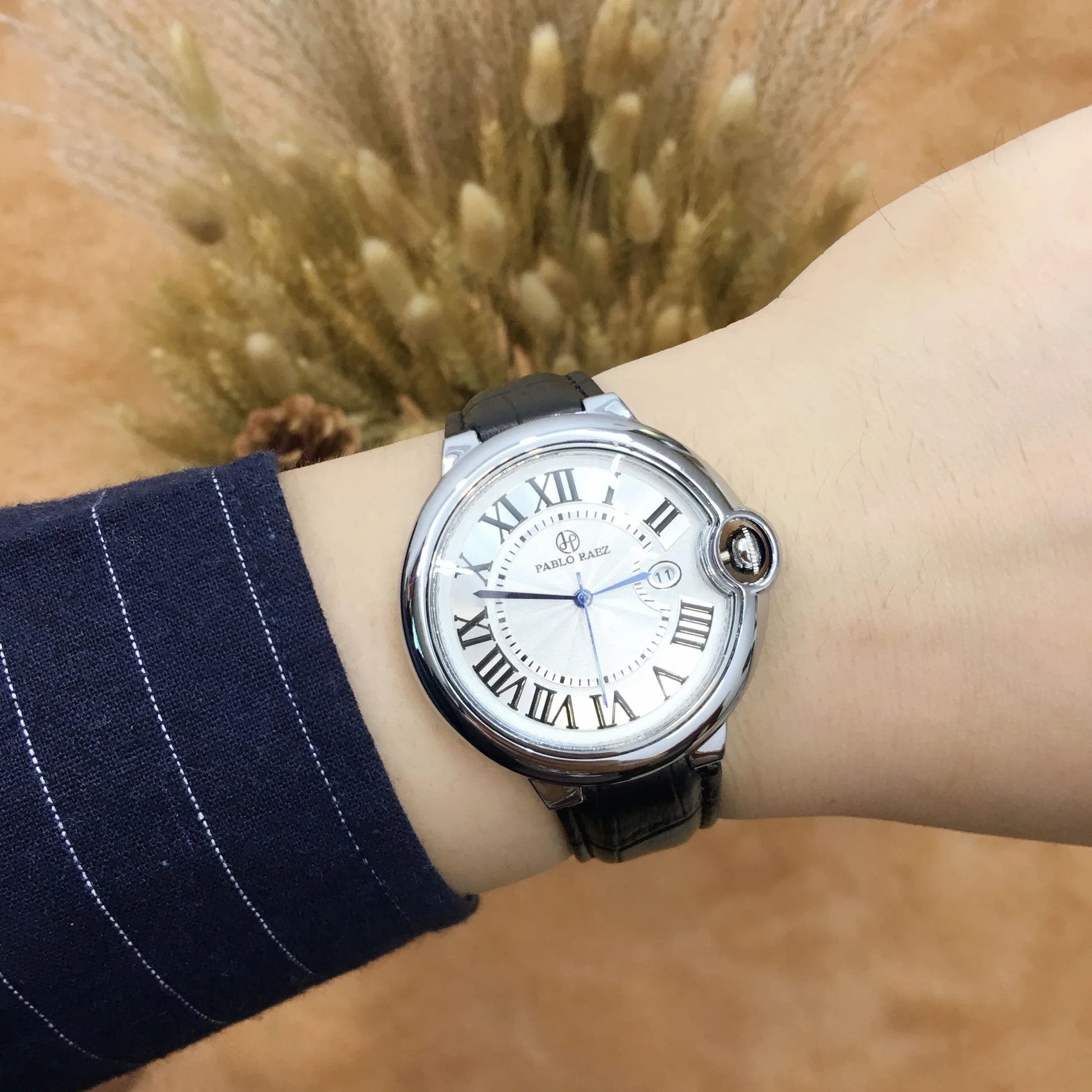 Stainless steel men's watch with large dial, calendar function, and adjustable band