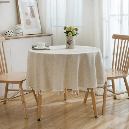 Sophisticated cotton-linen blend round tablecloth with elegant tassels, available in multiple sizes for versatile dining settings