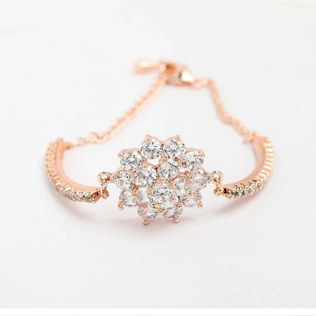 Elegant rose gold cubic zirconia bracelet with intricate cross, crown, and Roman numeral design