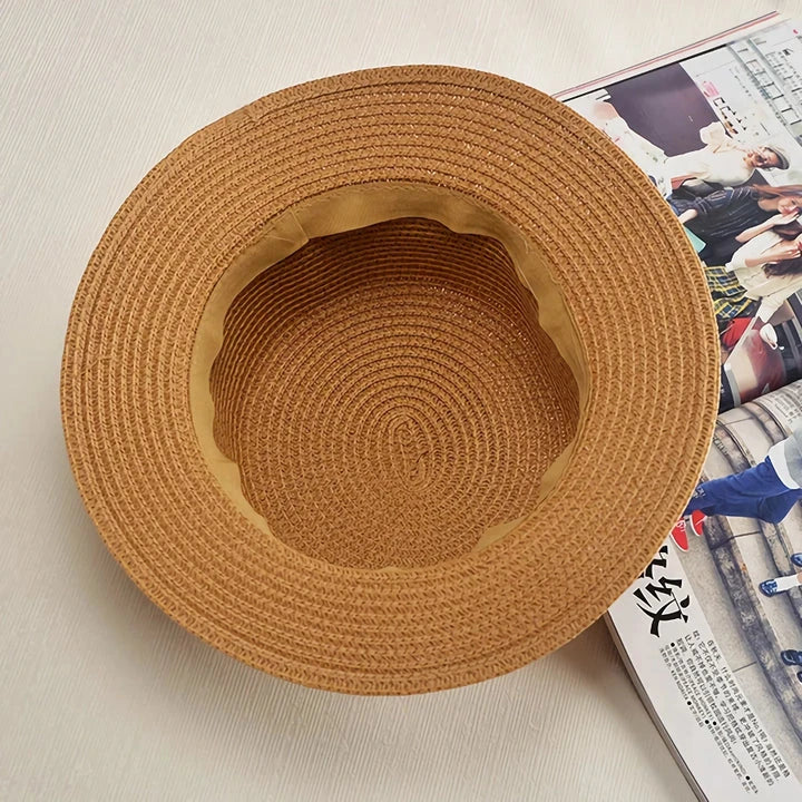 Classic straw Panama hat with a bow detail, offering sun protection and fashionable summer style