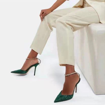 Glamorous rhinestone-embellished stiletto sandals in black and green colors, featuring a pointed toe and sleek silhouette
