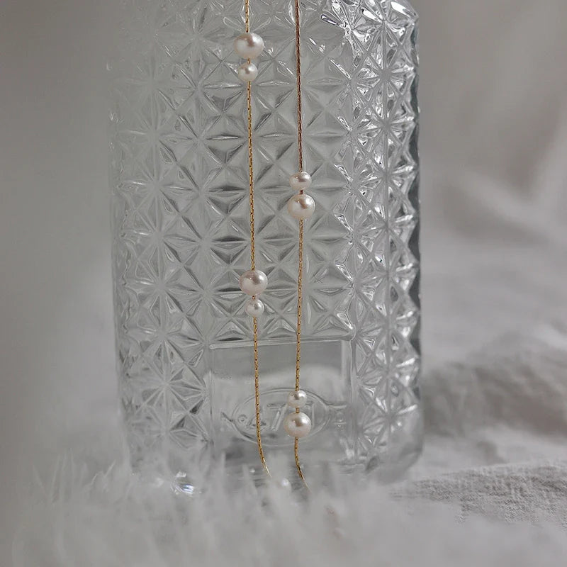 Elegant mother-of-pearl necklace with delicate butterfly and dragonfly motifs, inspired by Asian design