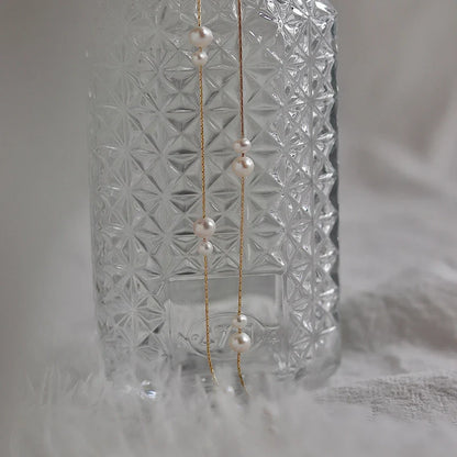 Elegant mother-of-pearl necklace with delicate butterfly and dragonfly motifs, inspired by Asian design