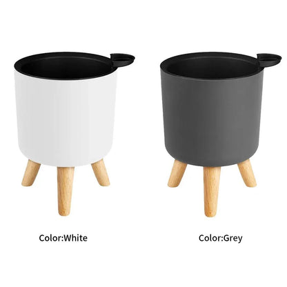 A modern self-watering planter with a wooden stand, designed to simplify indoor gardening and enhance any space with its chic and functional features.