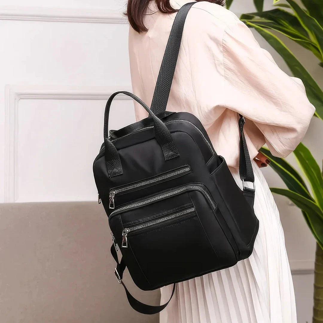 A stylish and durable Oxford cloth backpack with multiple compartments for organized storage and a sleek, portable design.