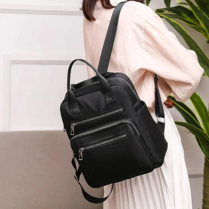 A stylish and durable Oxford cloth backpack with multiple compartments for organized storage and a sleek, portable design.