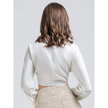 Elegant white vintage-inspired crop blouse with v-neck and long sleeves, a timeless and versatile wardrobe essential