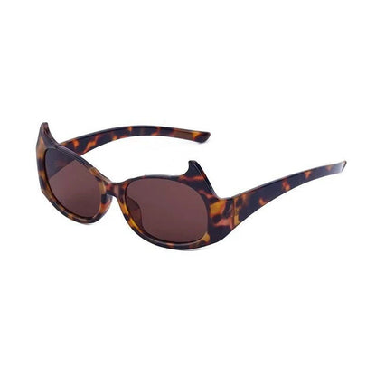 Stylish cat-eye sunglasses with oversized frames, semi-rimless design, and punk-inspired detailing for a timeless, glamorous look