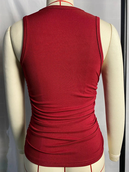 A sleeveless ribbed knit tank top for women in a variety of colors and sizes, featuring a crew neck design and pleated details for a stylish, casual look.