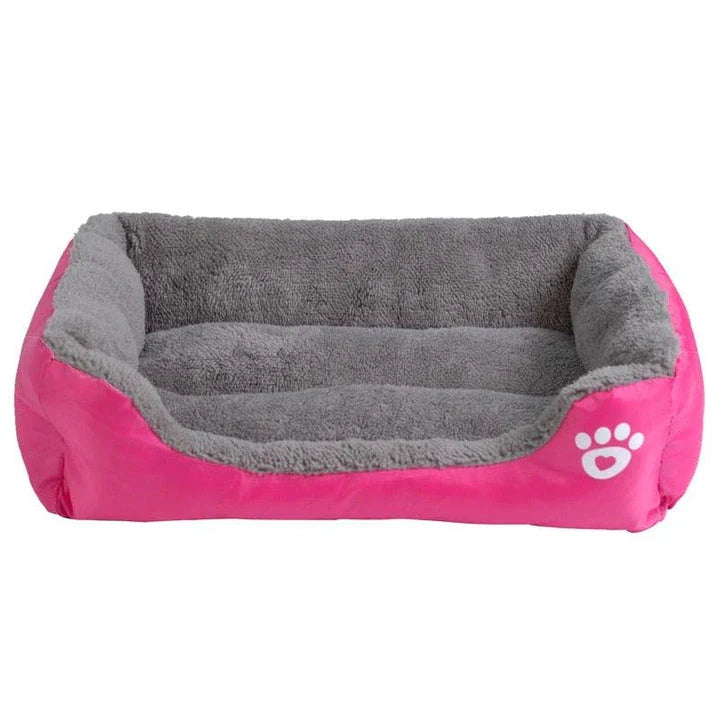 A plush, green pet bed with a paw-print pattern, designed to provide cozy and waterproof comfort for pets.