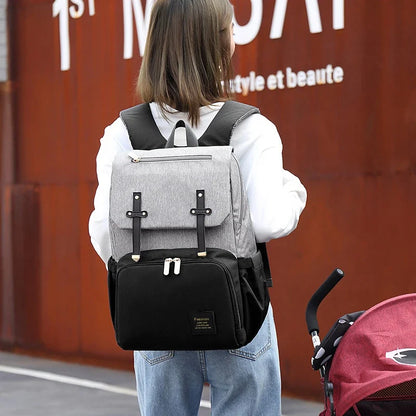 Premium diaper backpack with insulated pockets, stroller attachment, and USB charging port