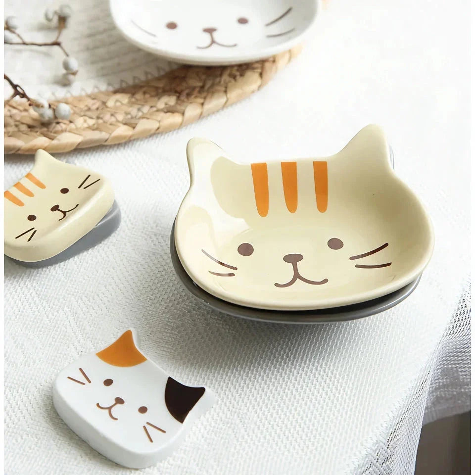 A charming Japanese-style ceramic dish featuring a cute cat design, perfect for serving sauces, dips, and small portions in style.