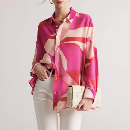 Elegant silk crepe de chine blouse in a unique print design, featuring a loose, straight fit and full-length drop sleeves for a modern, sophisticated look.