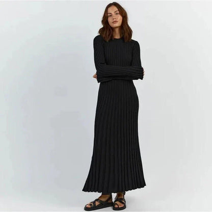 Timeless elegant pleated knit dress in black, perfect for summer office wear with a sophisticated and comfortable design.