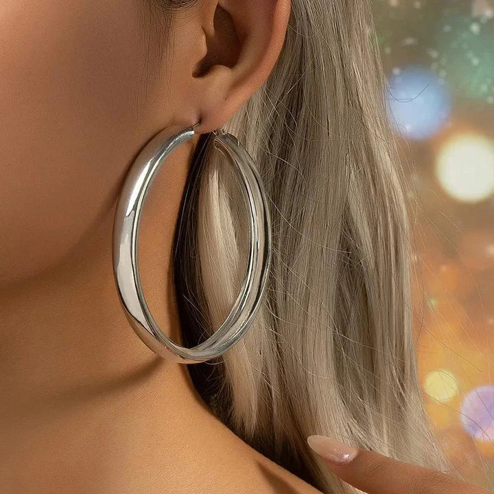 Glossy geometric metal hoop earrings in a silver finish, a trendy and versatile fashion accessory