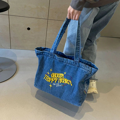 A stylish denim shoulder bag with embroidered details, perfect for everyday use and carrying all your essentials