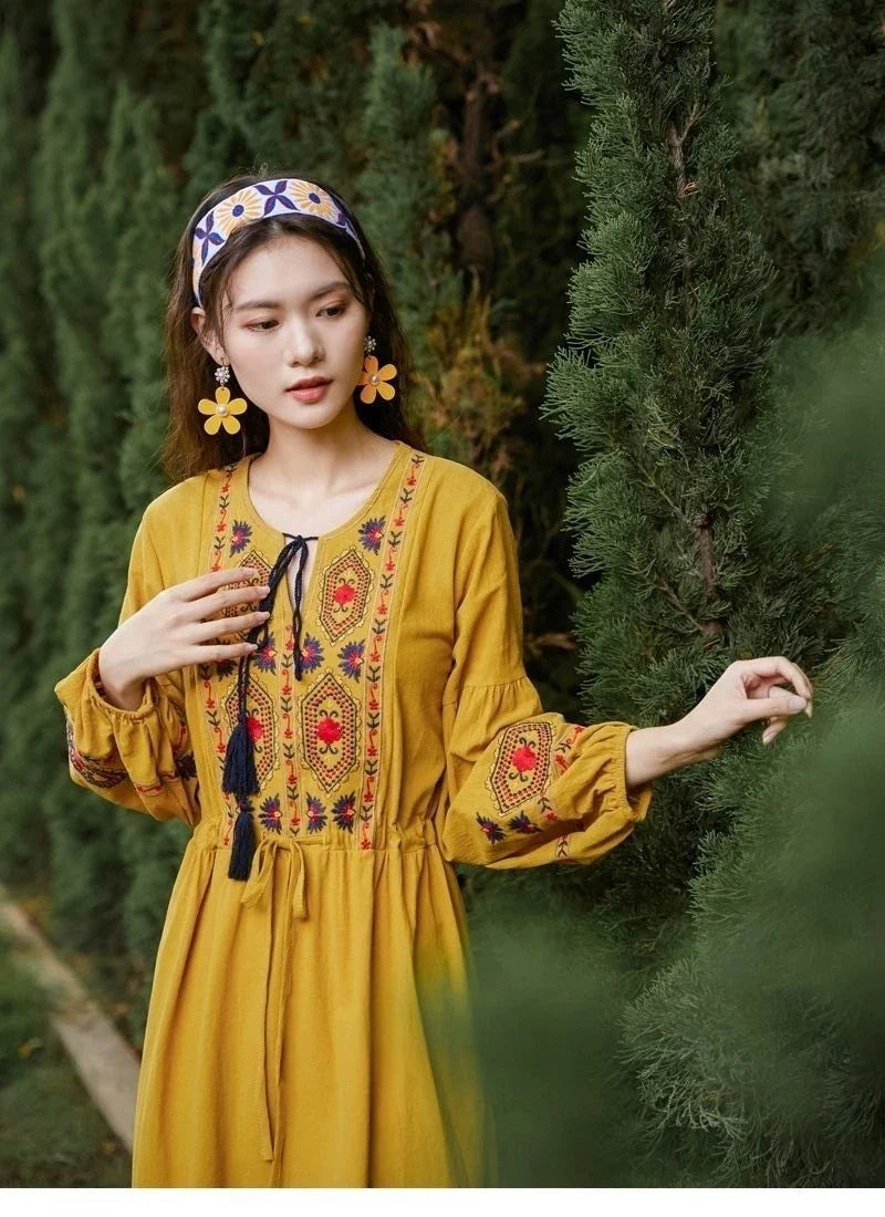 Elegant embroidered cotton-linen dress with tassels, featuring a waist-cinching A-line silhouette in vibrant colors