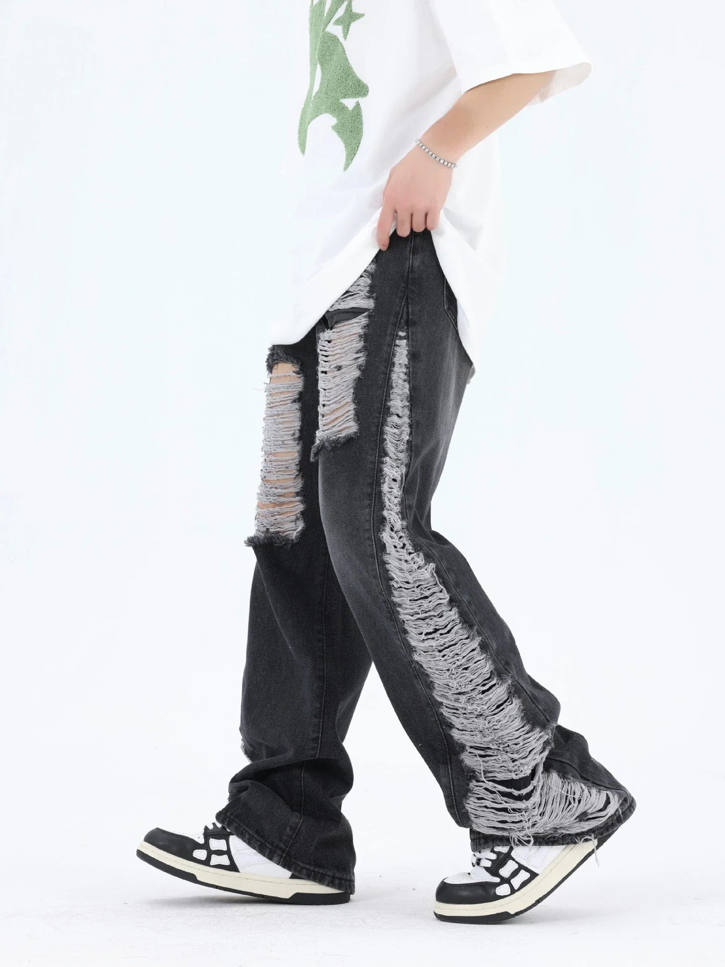 Premium loose fit distressed denim trousers for men and women, featuring a relaxed silhouette, high-quality cotton construction, and trendy distressed details.