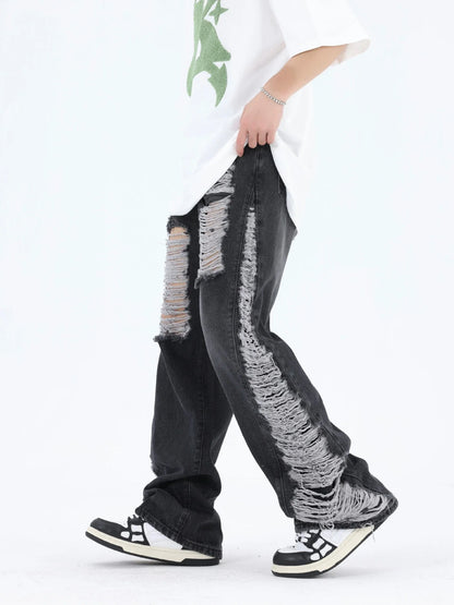 Premium loose fit distressed denim trousers for men and women, featuring a relaxed silhouette, high-quality cotton construction, and trendy distressed details.