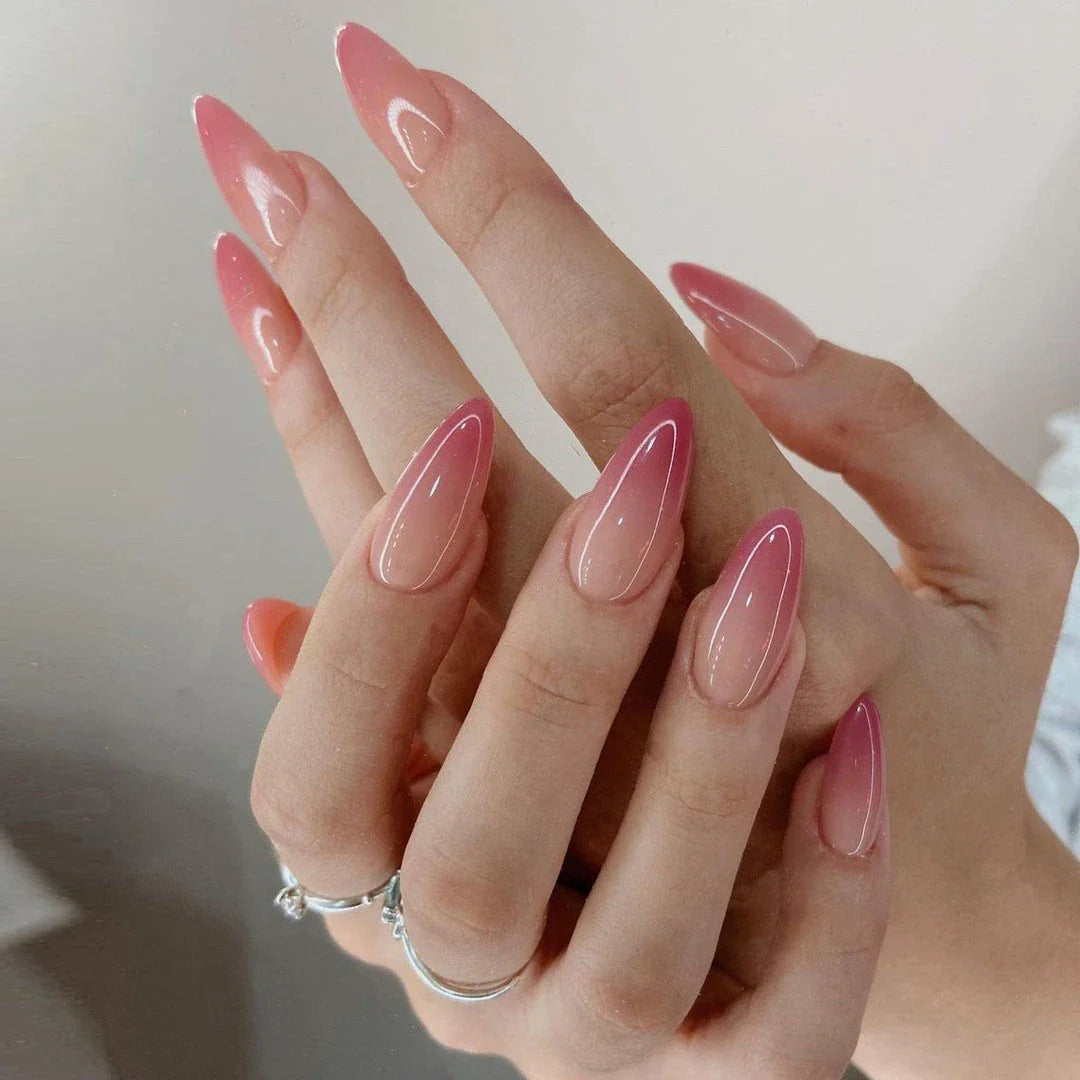 Gradient pink almond-shaped artificial nails with a glossy finish, perfect for elevating your style and transforming your look.