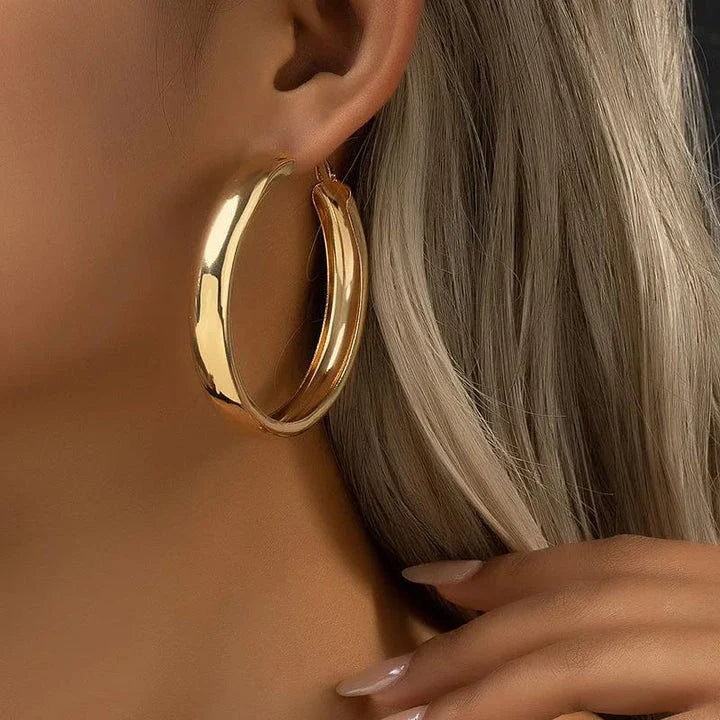 Glossy geometric metal hoop earrings in a silver finish, a trendy and versatile fashion accessory