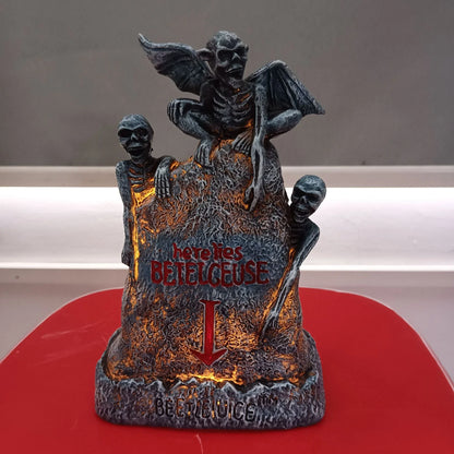 Glowing ghost skull tombstone decor with a spooky, otherworldly glow for Halloween