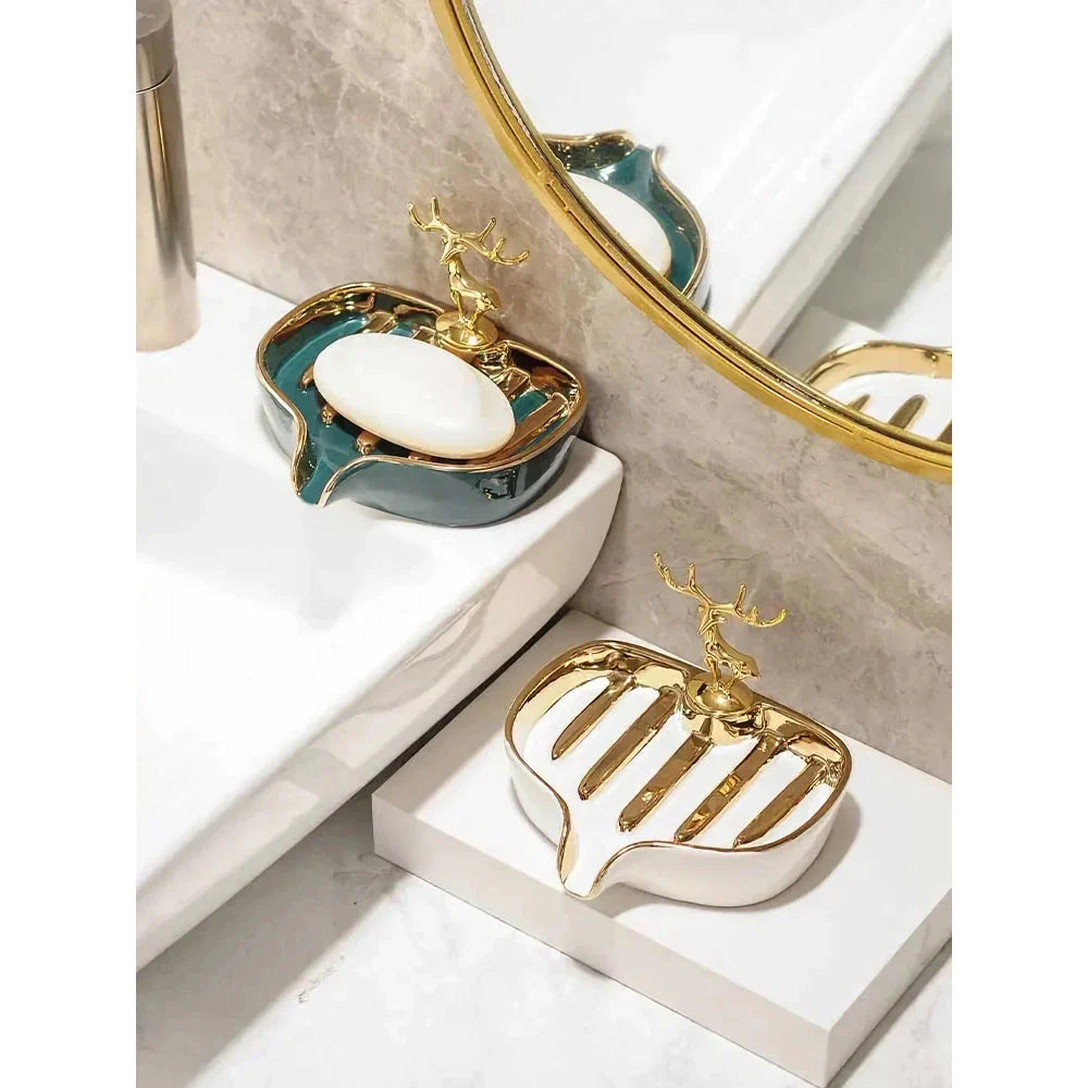 A white gold ceramic soap dish with a drainage design, showcasing a sleek and elegant bathroom accessory.