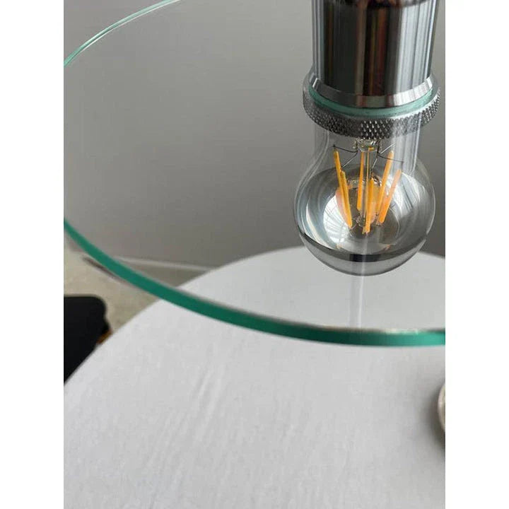 Elegant clear glass pendant light with a minimalist white lampshade, perfect for illuminating dining areas and bedrooms in modern homes.